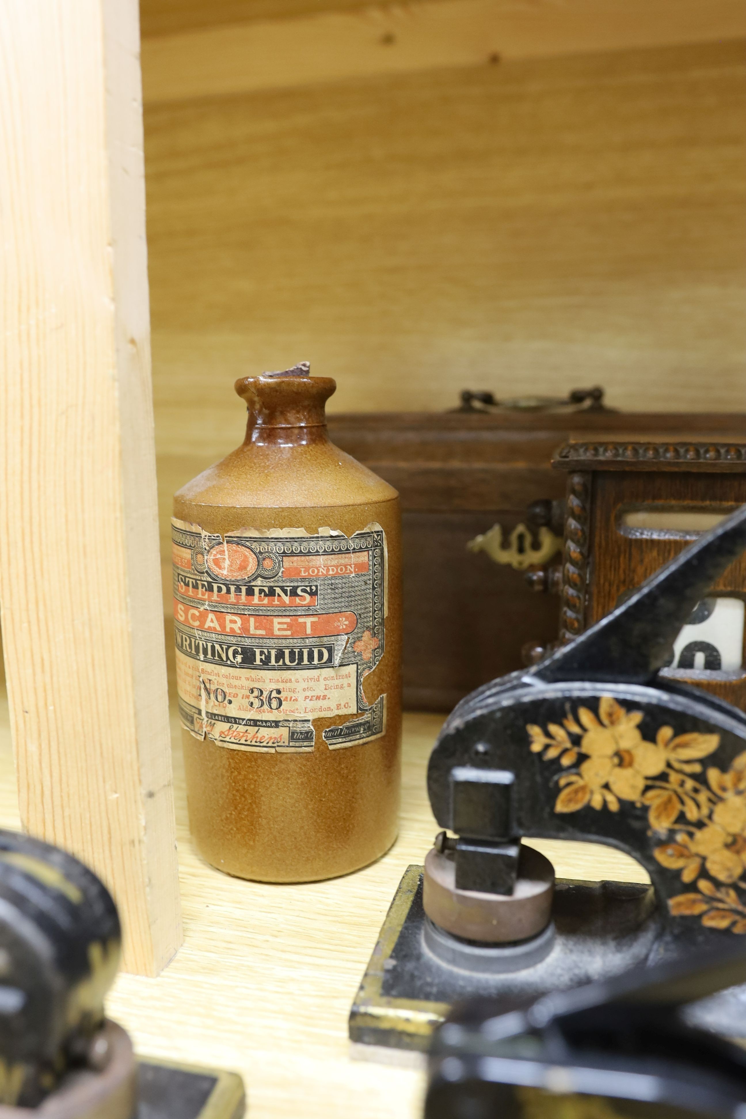 Three Victorian style desk embossing stamps, a terracotta bottle of Stephens 'Scarlet Writing Fluid', a desk calendar, oak box and a desk stand